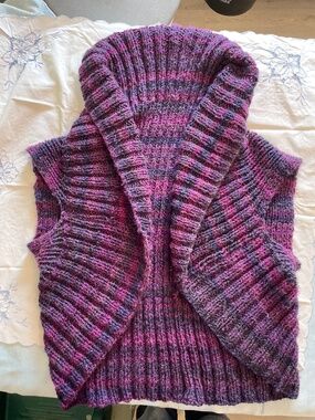 This is a handmade, chunky ribbed knit cardigan in shades of purple and charcoal